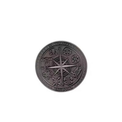 Custom embossed round brass coin with intricate 3D design