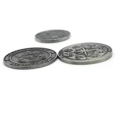 Custom embossed round brass coin with intricate 3D design
