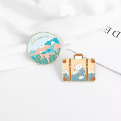 New travel adventure enamel metal pin with vibrant colors and detailed design